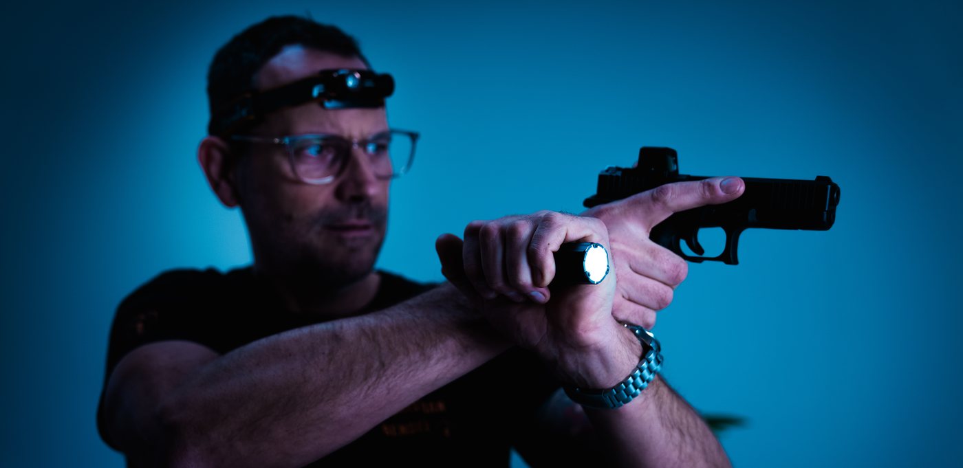 Kurzwaffe und Handlampe beim Low-Light-Training
